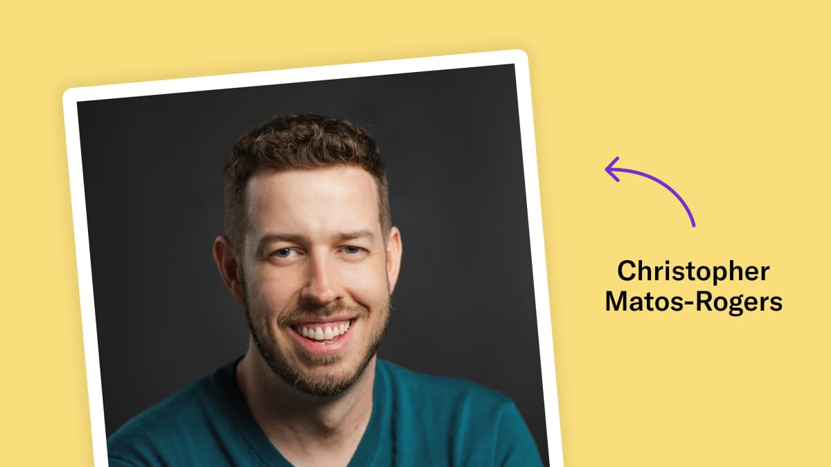 Studio headshot of Christopher Matos-Rogers on a dark grey background. He is smiling and wears a teal v-neck sweater, and has short light brown curly hair and short facial hair. The photo is overlaid on a yellow background with the text 'Christopher Matos-Rogers' and a purple arrow pointing to the image.
